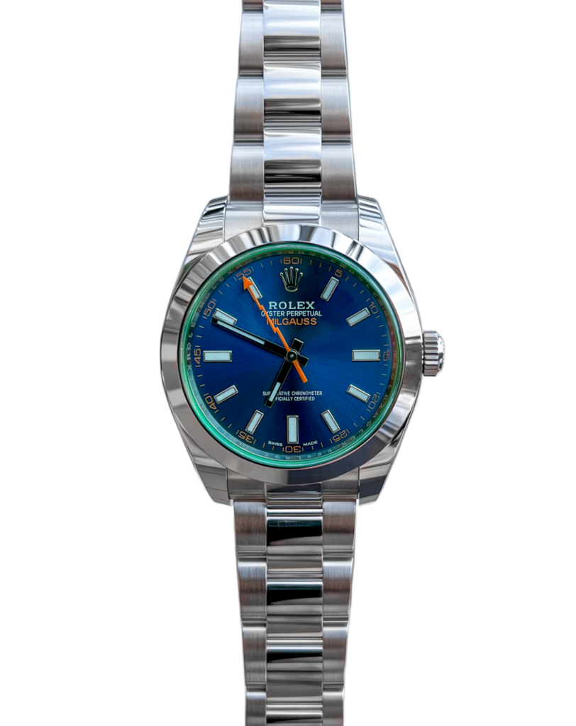 A detailed image of a Rolex wristwatch model 116400GV, also known as the "Green Crystal Milgauss." The watch showcases a stainless steel case and bracelet with a vibrant green-tinted sapphire crystal, giving it a unique and eye-catching appearance. The black dial features orange hour markers and hands, along with a distinctive orange lightning bolt-shaped second hand. At the 3 o'clock position, a date window is displayed. The Rolex logo is elegantly positioned at the 12 o'clock position.