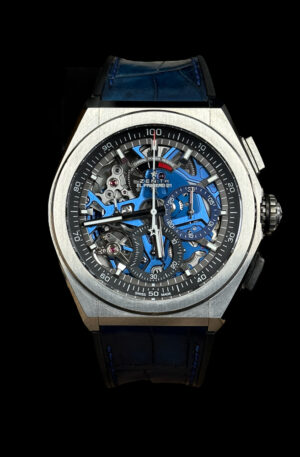 A Zenith watch with a blue strap and blue dial.