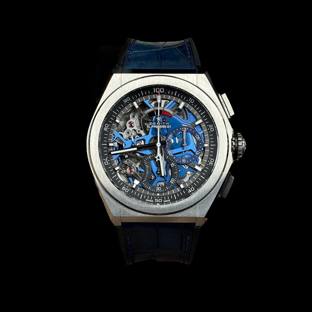 A Zenith watch with a blue strap and blue dial.